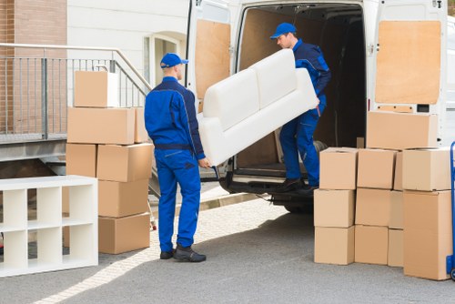 Professional movers handling office equipment during relocation