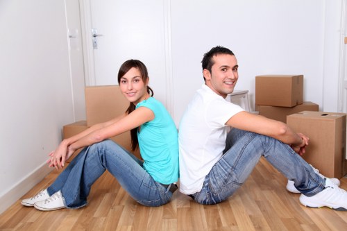 Local movers securing a piano for transport in South London